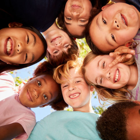 bigstock-A-huddle-of-school-kids-lookin-258026434